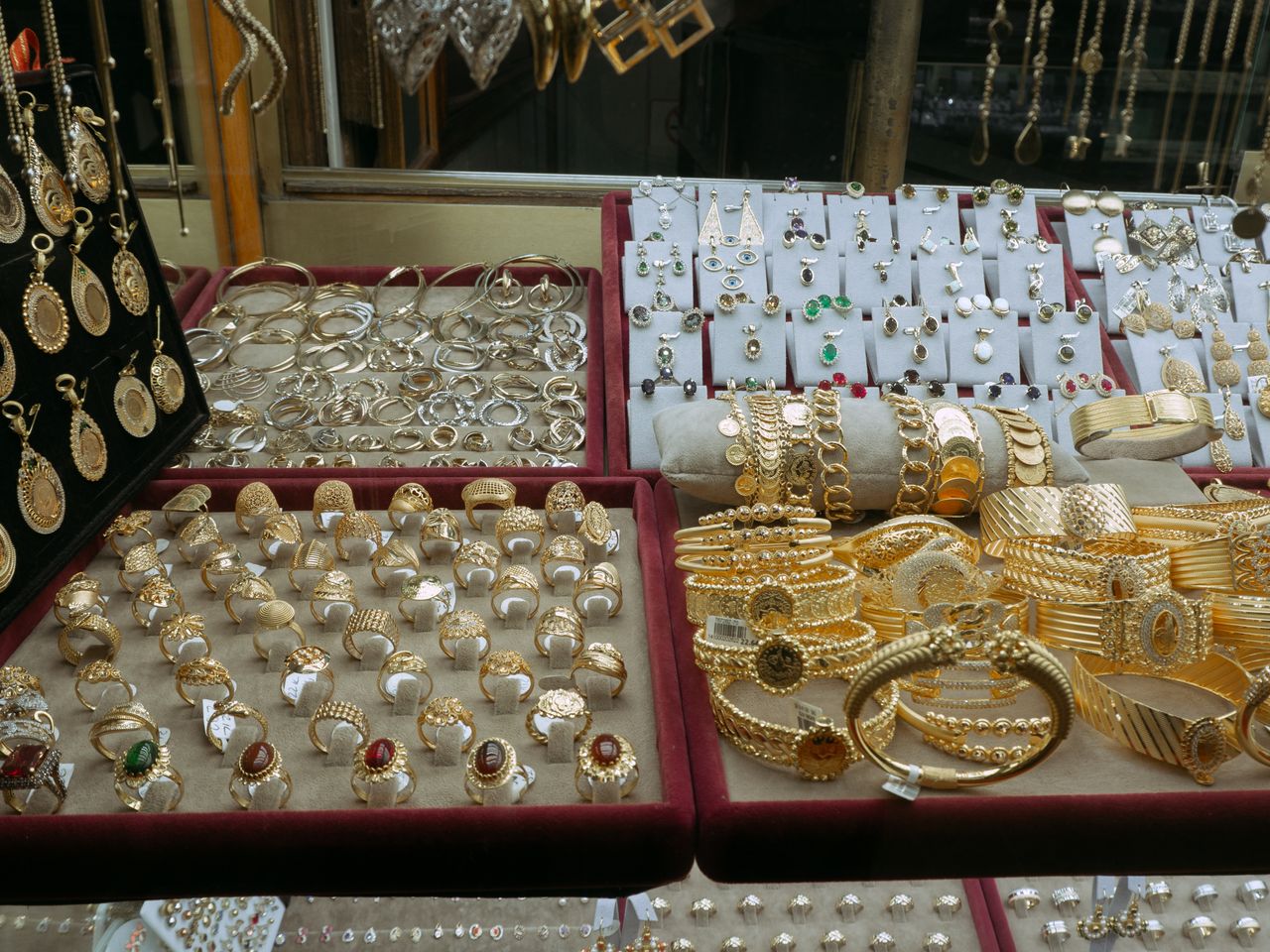 Showcase of elegant gold and silver jewelry in an Istanbul markets display case.